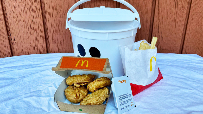 Nuggets, fries, honey, and bucket