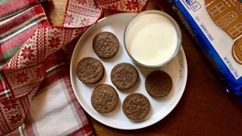 a plate with limited edition seasonal holiday gingerbread oreo cookies on a plate with a glass of milk