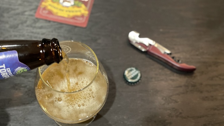 pouring a beer into a glass