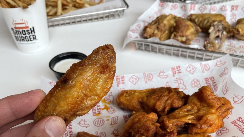 Smashburger chicken wing in hand