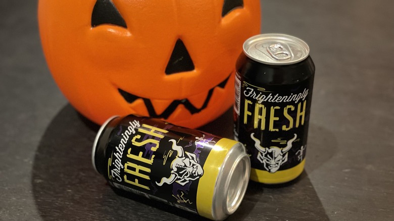 Cans of beer with a pumpkin pail