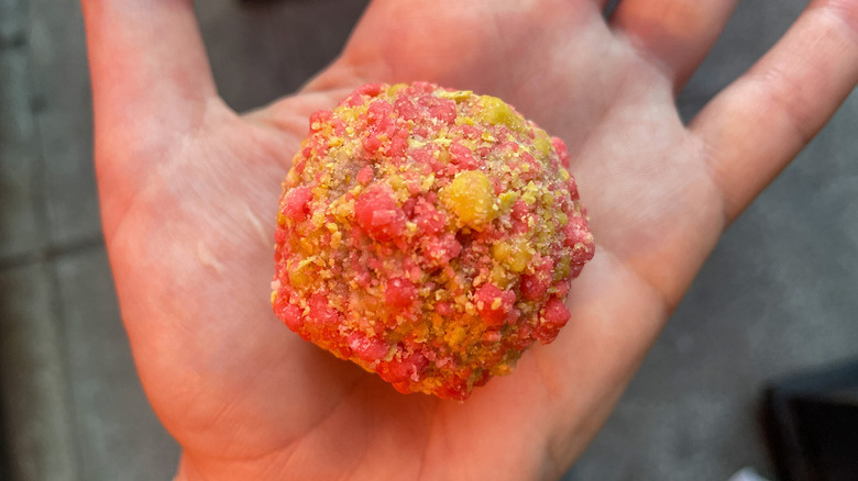 A strawberry bell cake truffle from milk bar and taco bell in NYC