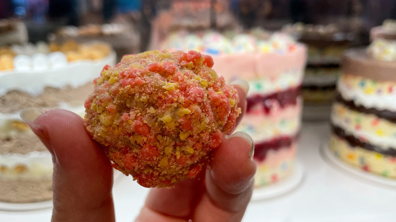 The Strawberry Bell Cake Truffle in front of Milk Bar cakes