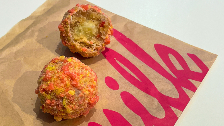 two strawberry bell truffles from milk bar and taco bell in NYC