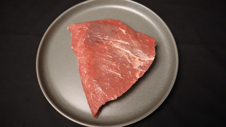 raw flat iron steak on a plate