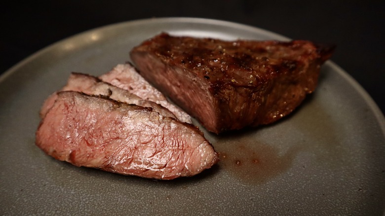 cooked and sliced flat iron steak on plate