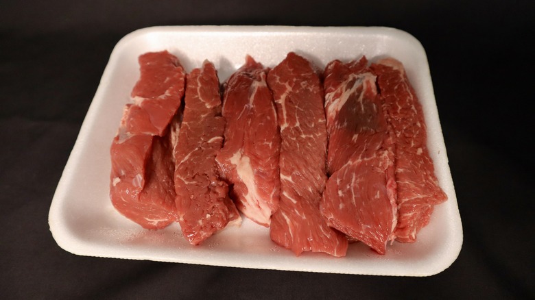 six uncooked beef ribs in package