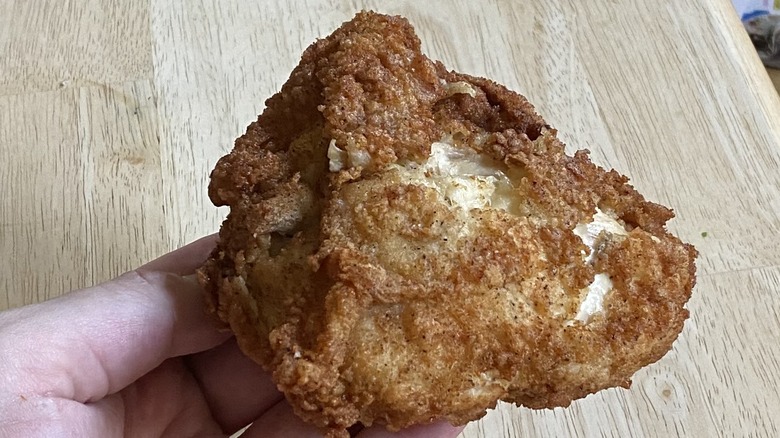 Man holding KFC chicken breast