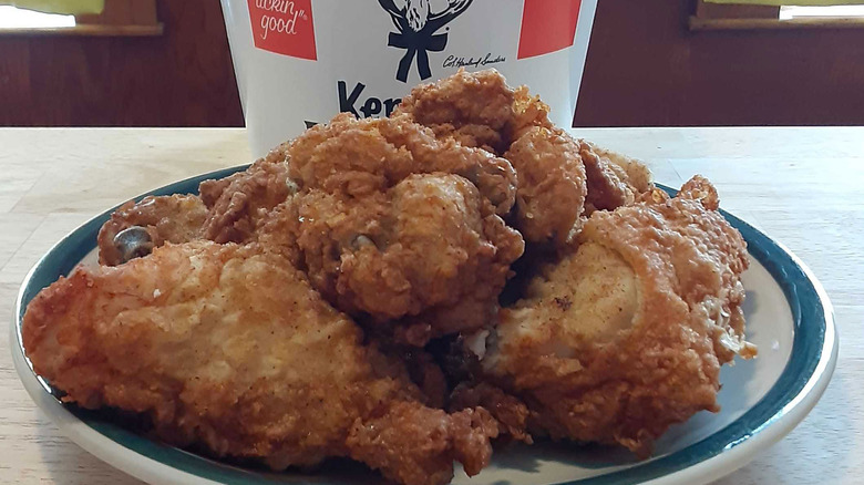 KFC chicken on plate in front of bucket