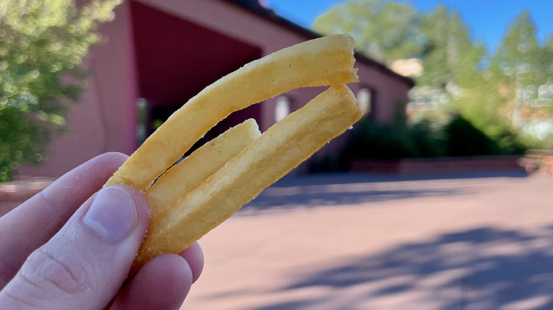 holding handful of fries