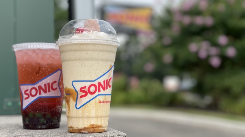 Two Sonic drinks on a ledge