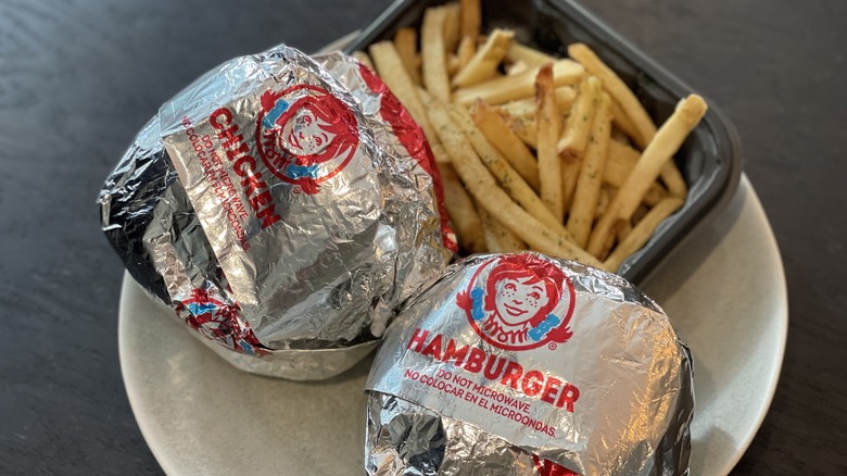 wrapped burgers and fries on a plate