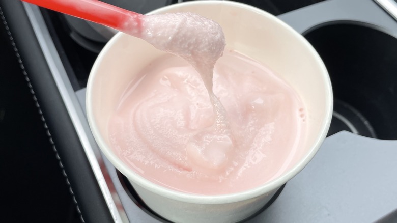 a pink Frosty in a car