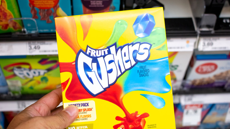 hand holding Fruit Gushers candies in box