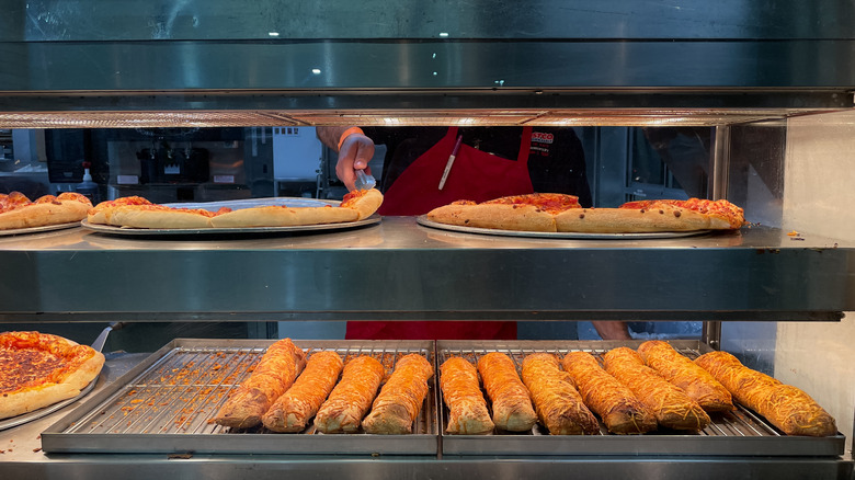 employee turning food at Costco 