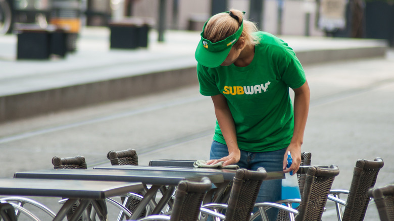 Subway worker cleaning