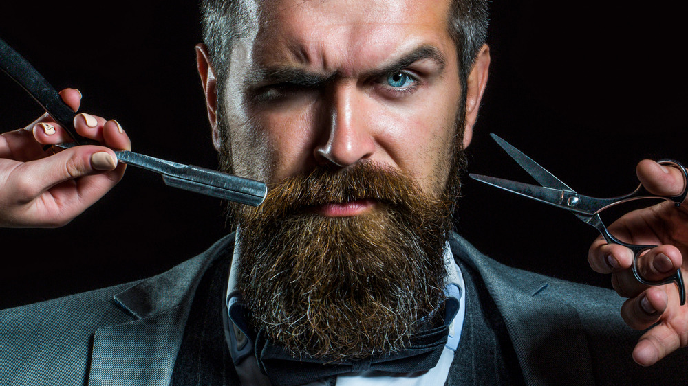 bearded man getting trimmed