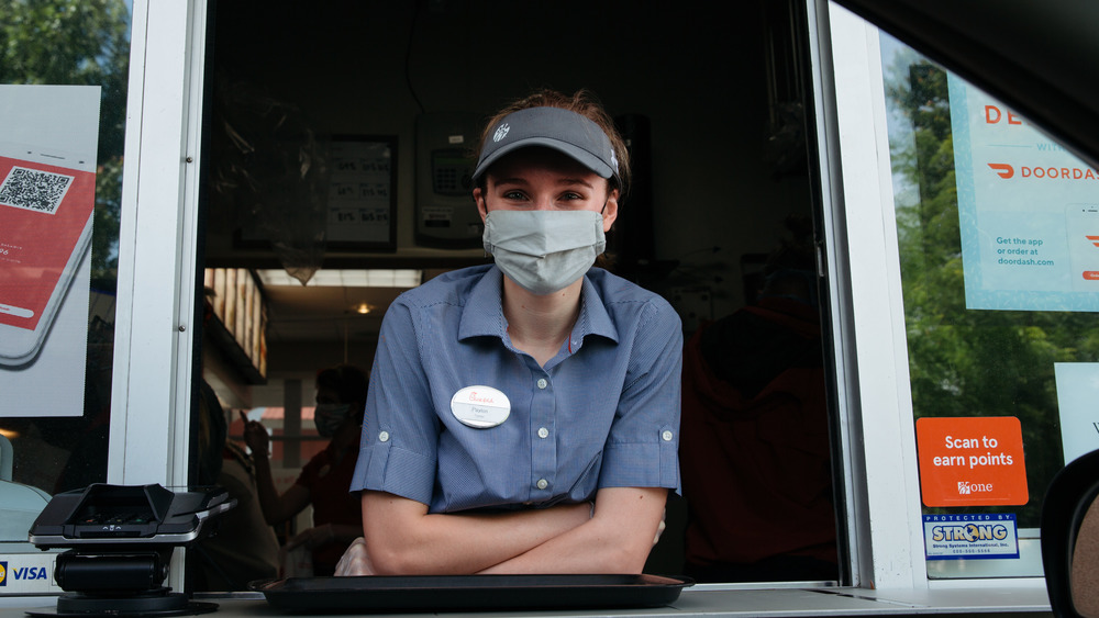 smiling Chick-fil-A employee at drive-through