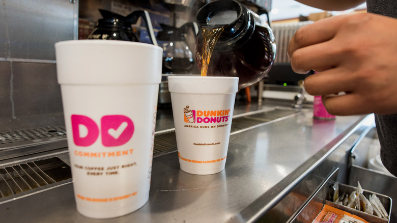 Pouring coffee at dunkin donuts 