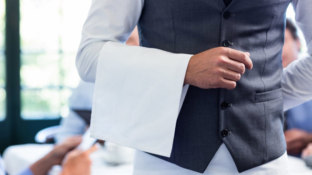 Waiter bringing a napkin at a fancy restaurant