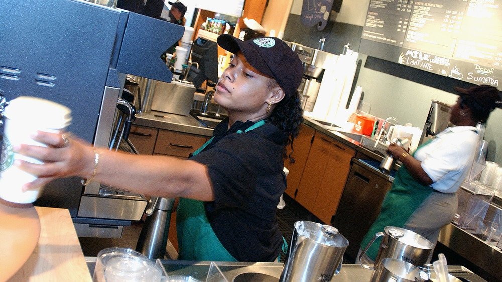 Starbucks worker making drinks