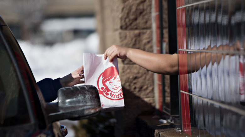 Wendy's customer picking up their food in the drive thru