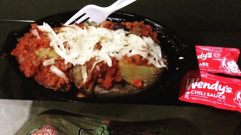 Loaded baked potato on a black dish