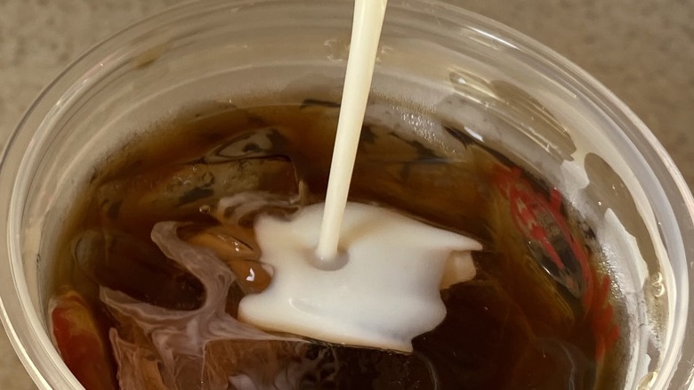 Cream entering cold brew coffee