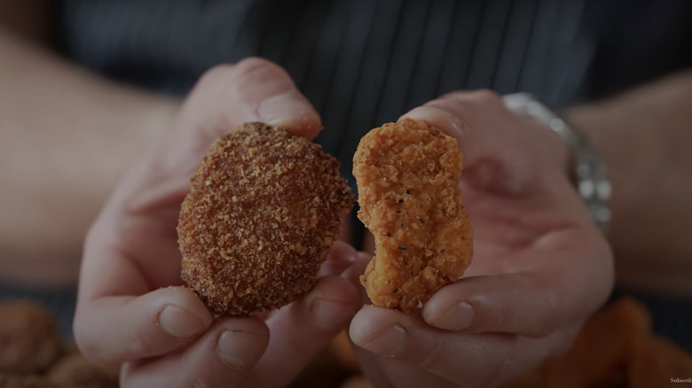 hand holding two types of spicy chicken nuggets