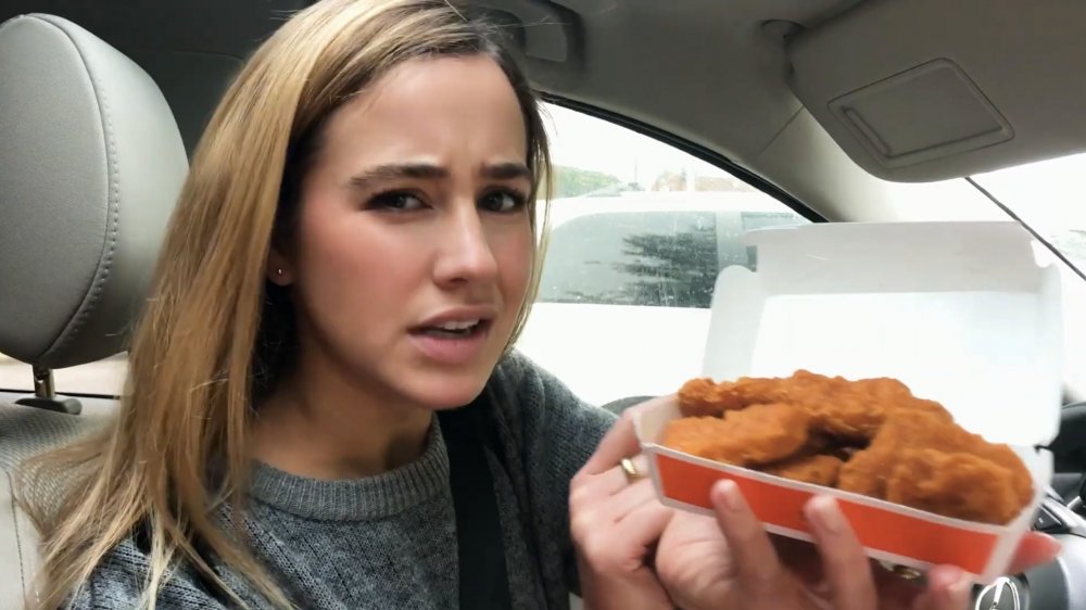 YouTuber Annie Campbell reviewing McDonald's spicy McNuggets