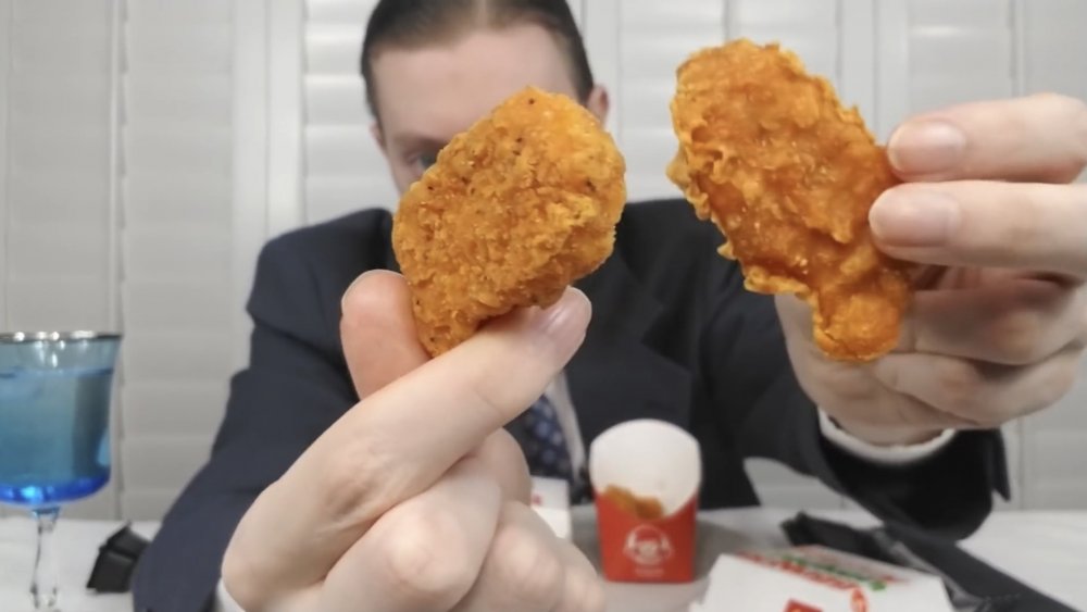 YouTuber John Jurasek showing Wendy's and McD's spicy nuggets