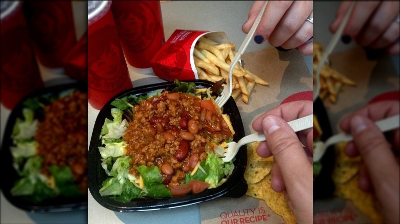 people sharing a taco salad