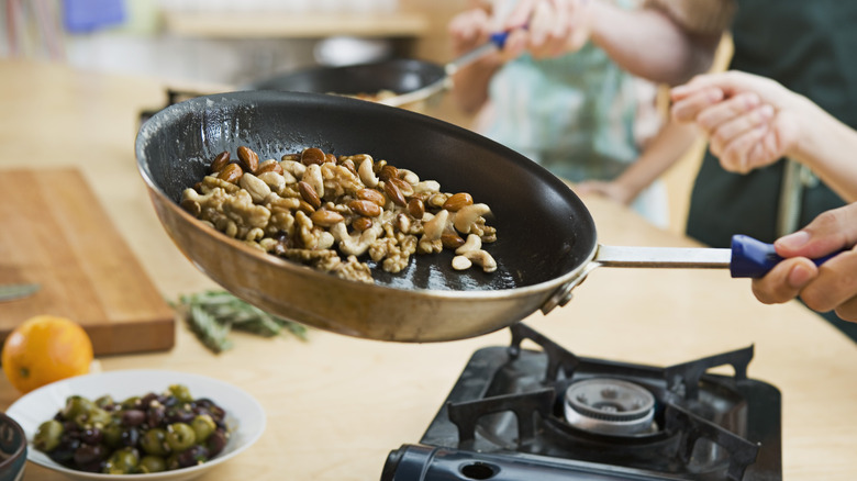 hand holding cooking pan