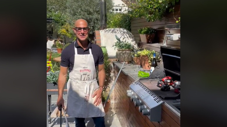 Stanley Tucci grilling outside