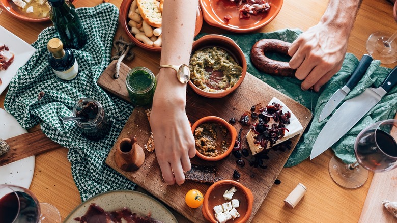 hands reaching for appetizers