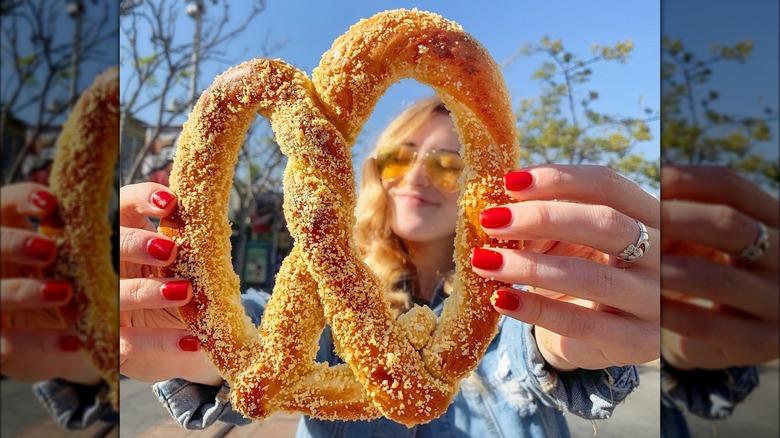 woman holding almond crunch pretzel 