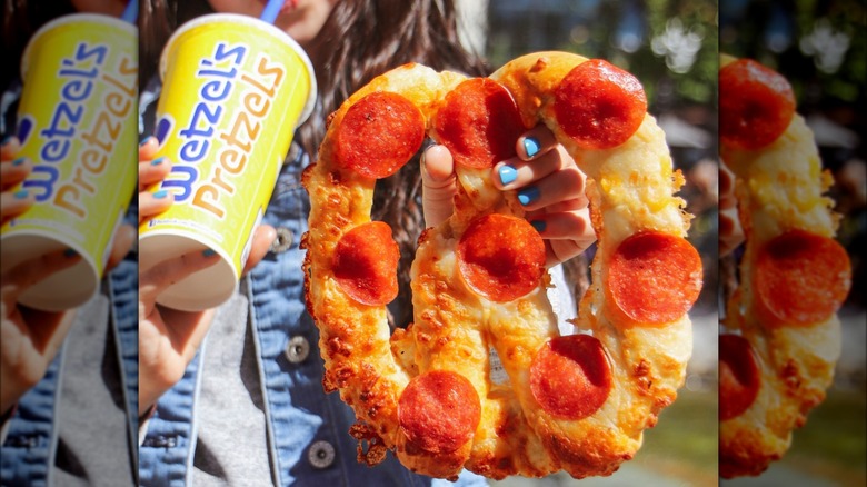 person with pepperoni cheese pretzel