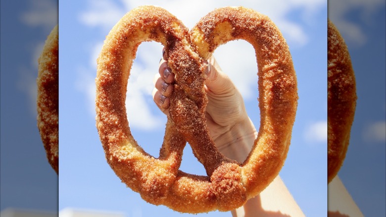 hand holding cinnamon pretzel