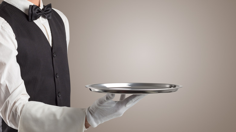 Waiter holding an empty tray