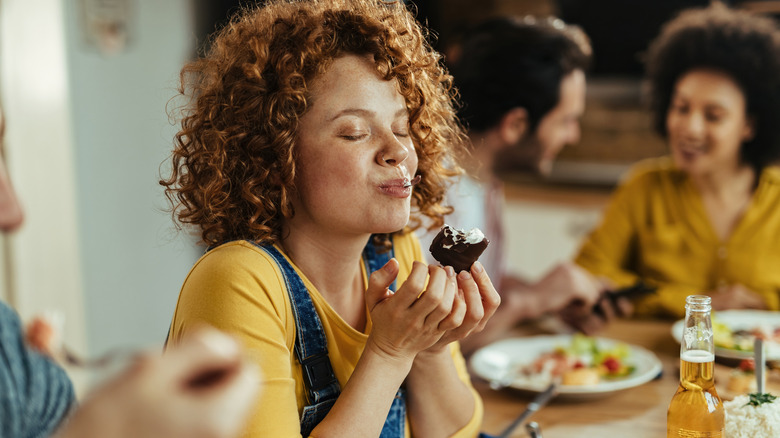 Person eating a dessert