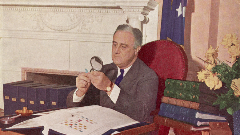 Franklin D. Roosevelt looking at stamps