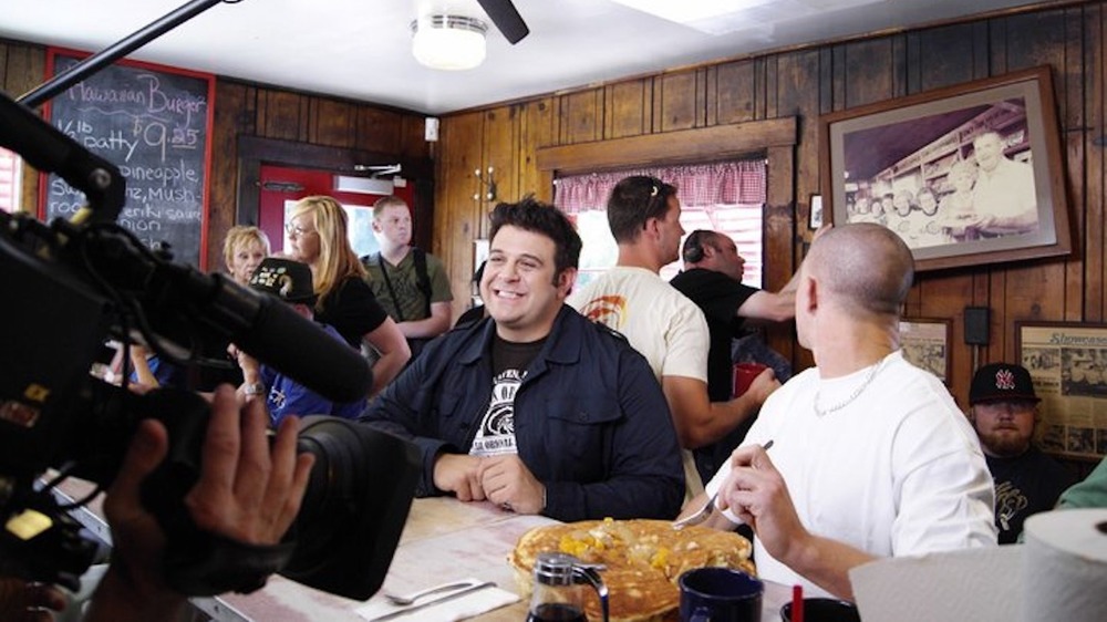 Adam Richman filming in a restaurant 