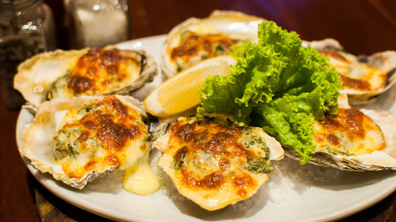 Plate of oysters covered in cheese