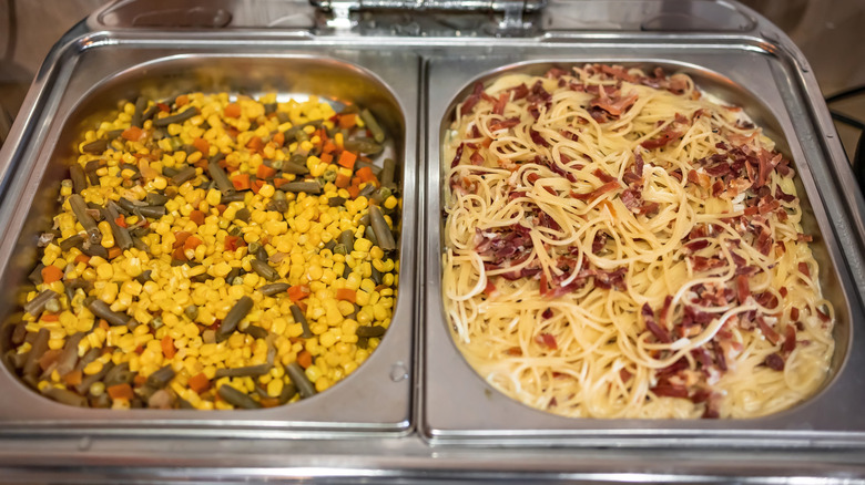 Pasta and corn at a buffet station