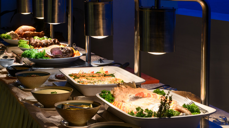 Food under heat lamps at buffet