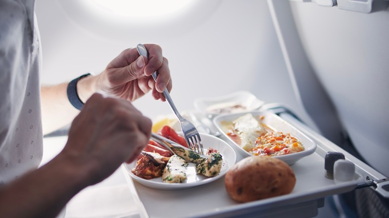 person eating airplane food