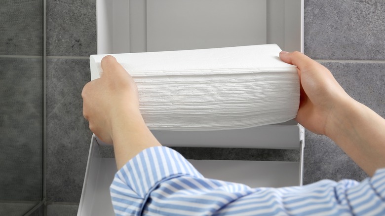 inserting C-fold towels into dispenser