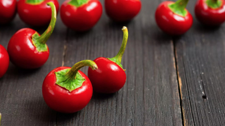 cherry peppers on dark wood table