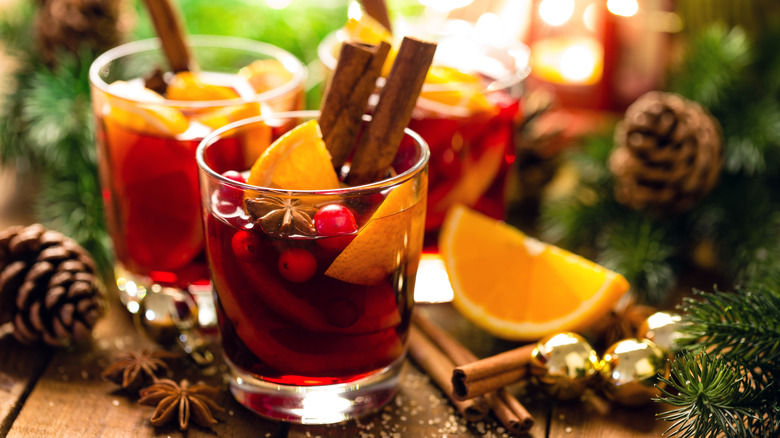 Mulled wine with spices on holiday background