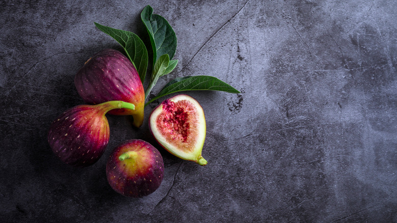 Ripe fig cut open on marble background